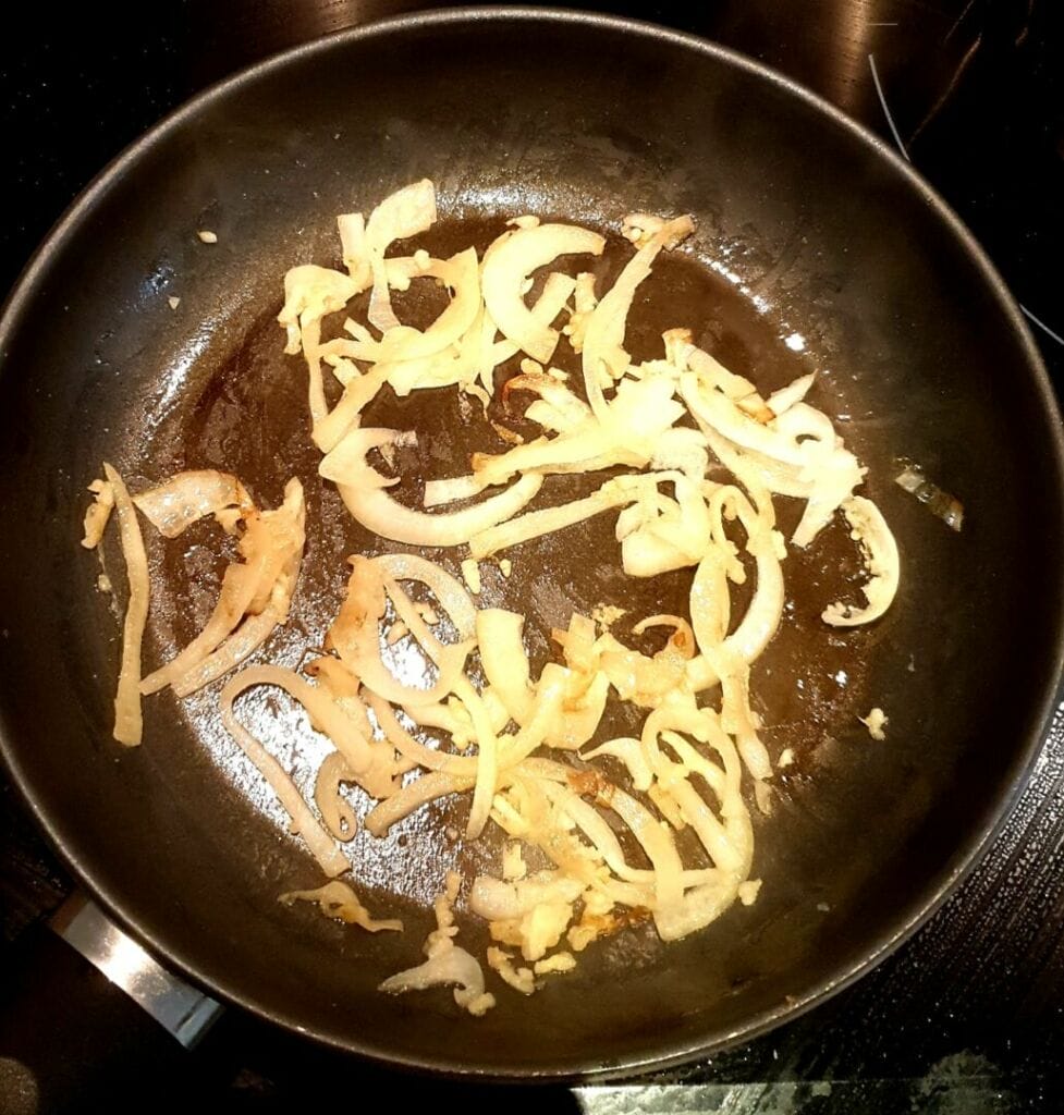 A delicious bowl of creamy rice mixed with vibrant red and yellow bell peppers